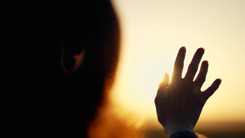 Silhouette of happy dreaming girl pulls her hand to sun.Religion helping hand. Happy girl pulls her hand.Prayer in religion.Silhouette of hand in sun.Happy girl silhouette at sunset.Freedom in nature Royalty-Free Stock Footage #1104585121