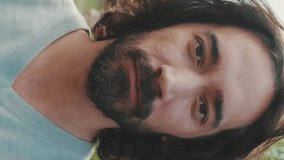 VERTICAL VIDEO: Close up, young smiling man looking at camera - Powered by Shutterstock - Get 15% off with code: PIKWIZARD15