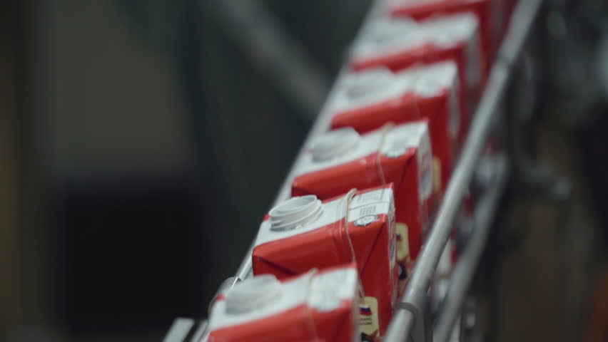 Packs With Milk Move On Conveyor Line At Dairy Manufacturing Factory. Conveyor Line For Milk Transportation. Milk Production At Close Up. Automated Conveyor Line At Plant. Modern Equipment. Royalty-Free Stock Footage #1104590107