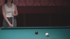 game of billiards. a brown-haired woman in a white T-shirt plays Russian billiards. real time video. High quality Full HD video recording