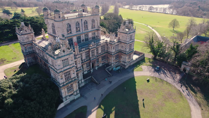 scenic drone shot of the front side of Wollaton Hall and visitors entering there, Nottingham, UK. High quality 4k footage