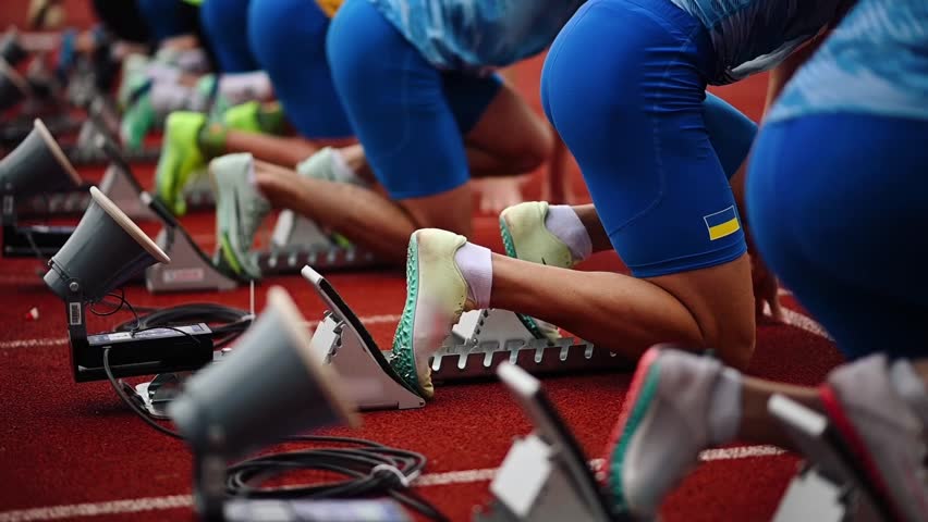 Low start of runners at the competition. Close-up