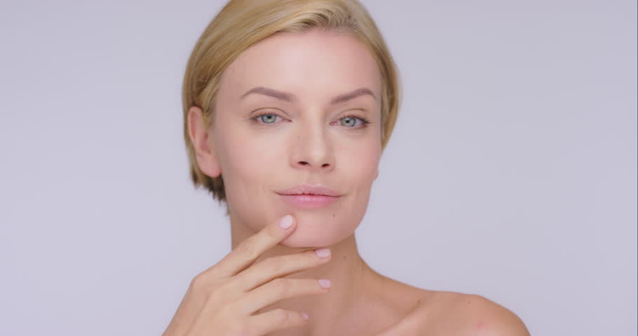 Face, thinking and mature woman with skincare, cosmetics and dermatology against a grey studio background. Portrait, female person and model with thoughts, ideas and wellness with luxury and beauty | Shutterstock HD Video #1104599083