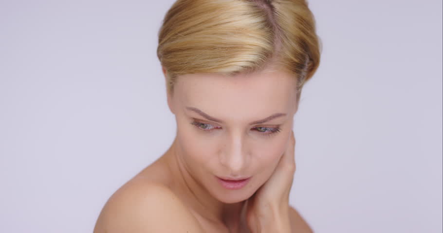 Face, dermatology and mature woman with beauty, cosmetics and spa treatment against a grey studio background. Portrait, female person and model with wellness, luxury and skincare with salon grooming | Shutterstock HD Video #1104599087