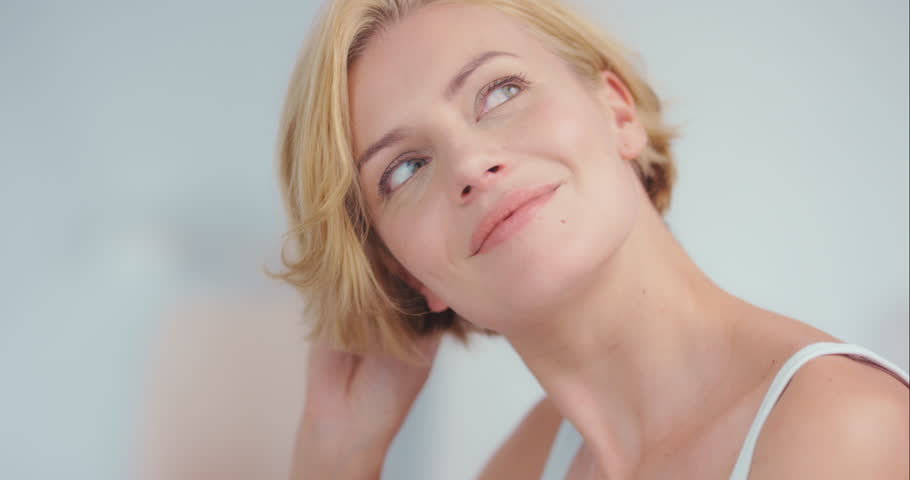 Woman, face and smile with beauty and skin, antiaging cosmetic treatment and clean skincare. Natural cosmetics, happy female model and facial with portrait, dermatology and wellness with glow | Shutterstock HD Video #1104599109