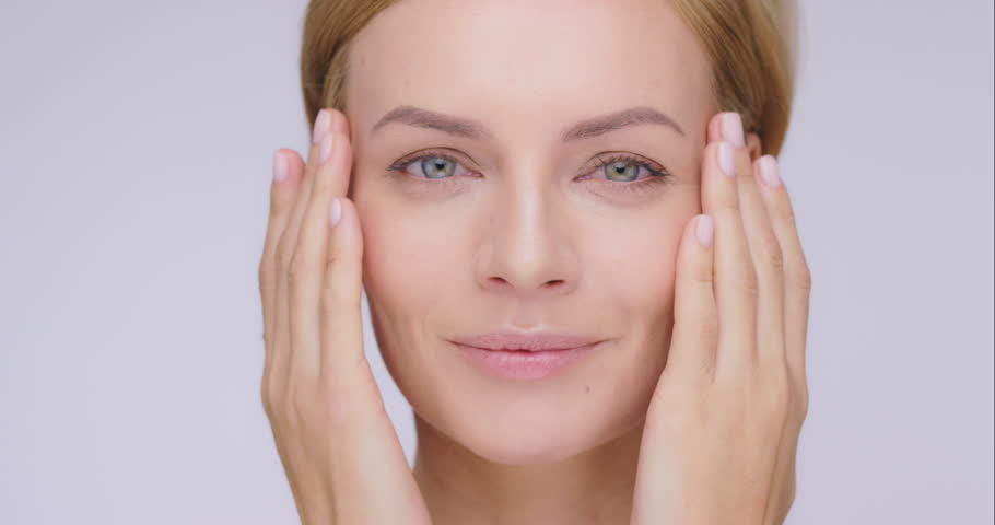 Face, beauty and mature woman with skincare, cosmetics and dermatology against a grey studio background. Portrait, female person and model with salon treatment, spa grooming and wellness with luxury | Shutterstock HD Video #1104599111