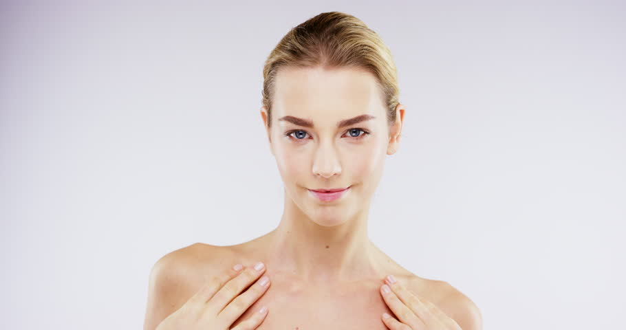 Face, dermatology and woman with cosmetics, wellness and pamper treatment against a white studio background. Portrait, female person and model with skincare, grooming routine and beauty with luxury | Shutterstock HD Video #1104599155