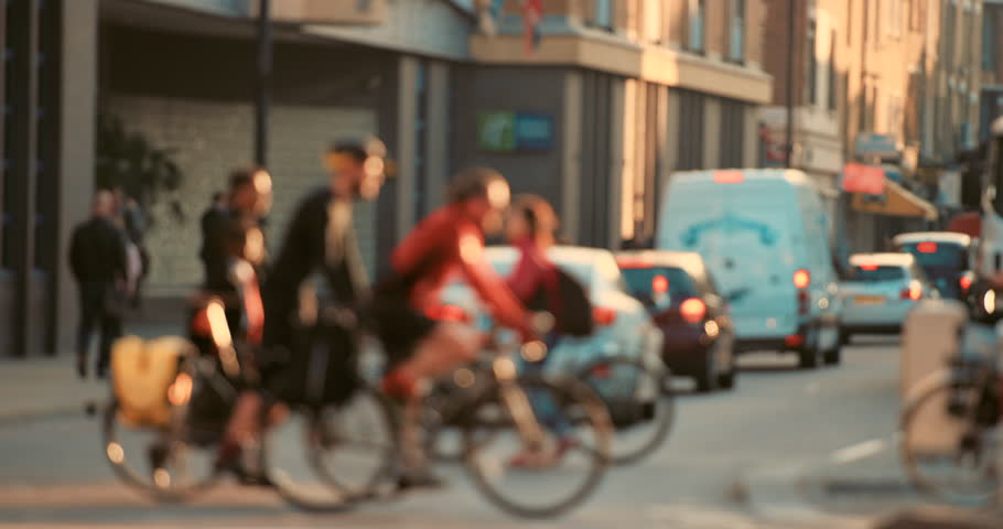 People, blur and cycling with traffic, travel and street with cars, moving and carbon footprint with sustainability. Community, group or crowd with a cyclist, biker or walking with motion and bicycle Royalty-Free Stock Footage #1104599195