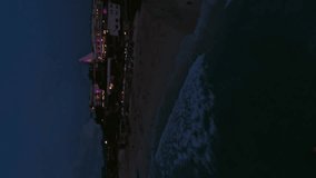 Vertical video. Scarlet clouds evening sunset island sea summer ocean at calm water surface aerial view. FPV sport drone low straight forward dynamic speed morning sunrise shot picturesque red sky 4k