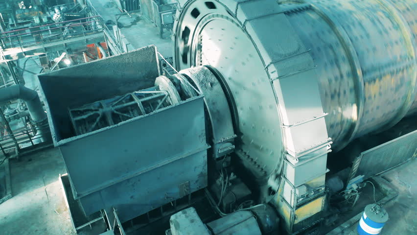 Top view of a grinding mill processing copper ore. Mining industrial conveyor at ore processing factory.