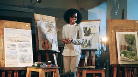 African-american woman is holding a remote art lesson. Art education concept.