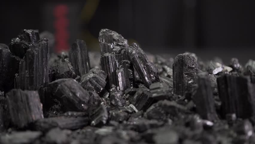 Mineral rocks black tourmaline obsidian stones with light, macro scene ready for design