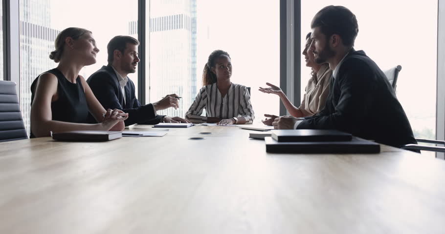 Group of diverse businesspeople, partners negotiate at meeting in boardroom. Multiethnic executive team discuss finances, partnership or future cooperation, working on project or strategy in office Royalty-Free Stock Footage #1104612349