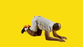 Sportive african man doing plank exercise on the floor