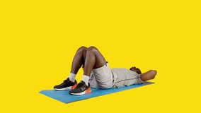African man on a mat doing roll up exercise