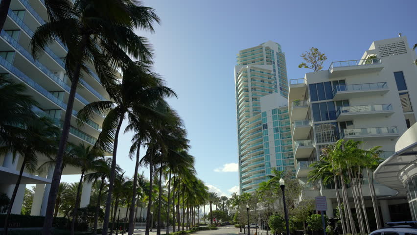 POV driving on Collins Avenue in Miami Beach. Florida road with moving traffic. Royalty-Free Stock Footage #1104620987