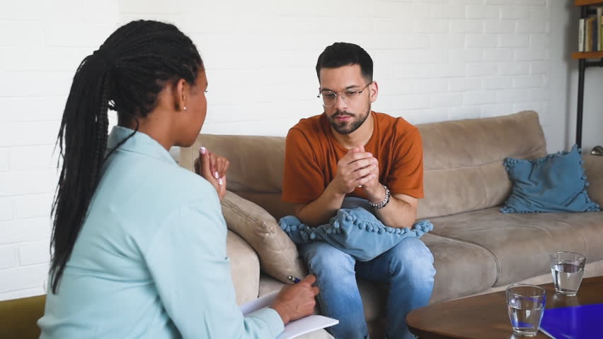 Stressed worried man suffering from depression and anxiety counselor providing professional assistance psychotherapy. Unhappy male patient consultation with psychologist, receiving therapy help Royalty-Free Stock Footage #1104623527
