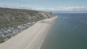 The Warren, Abersoch, Llyn Peninsula, North Wales - April 29th 2023: Aerial view of The Warren holiday park in Abersoch and the headland at Llanbedrog with blue seas, boats and jetskis. 