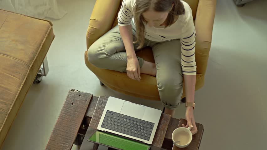 Woman working at desk in home office on laptop computer. Concept for website application or webshop, selling product online or internet education, learning on webinar. Top down from above view. Royalty-Free Stock Footage #1104628343