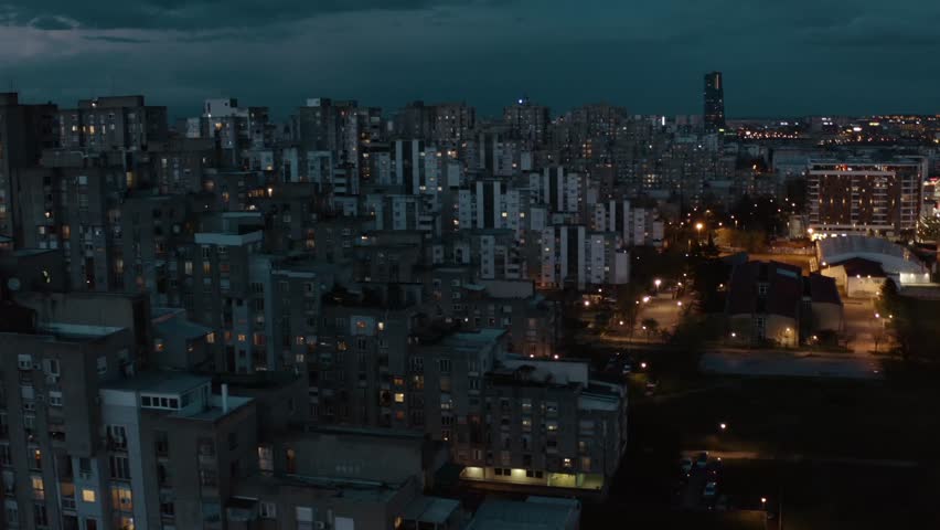 Aerial view of bloks of multi-stored houses, that were built during socialistic era in Yugoslavia. Cinematic dramatic view of a concrete towers in New Belgrade area. View from drone to blok 61 houses  Royalty-Free Stock Footage #1104629915