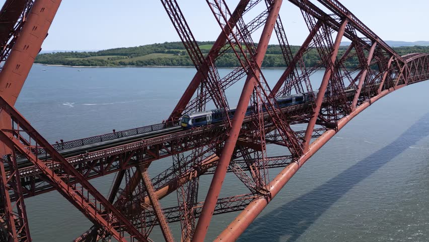 Trains pass in both directions over the Forth Rail Bridge in Queensferry, Scotland, UK. Filmed at 60fps. Royalty-Free Stock Footage #1104629935