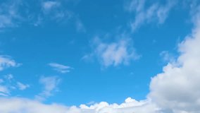 Blue sky and white time lapse sunny clouds, blue skies with natural cloudscape, fast motion mass in horizon.