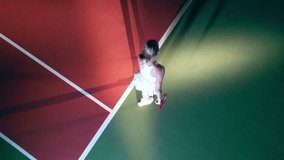 Top view of an athletic woman serving a tennis ball - Powered by Shutterstock - Get 15% off with code: PIKWIZARD15