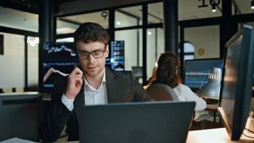 Investment manager talk cell in evening. Successful trading broker call client discussing forex bonds strategy. Busy man project leader work late browse computer. Finance analyst speaking mobile phone - Powered by Shutterstock - Get 15% off with code: PIKWIZARD15