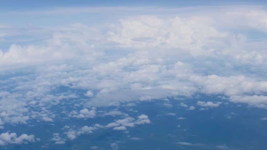 White fluffy clouds view from the window of an aircraft. Aerial view, flying in a plane at high altitude, High quality footage Royalty-Free Stock Footage #1104637151