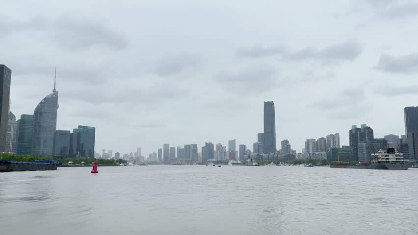 Boat and modern commercial buildings around Huangpu river, Shanghai China.
