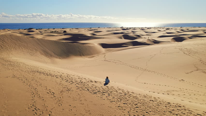 Aerial view of Maspalomas Dunes at Playa del Ingles beach at sunrise, Maspalomas, Gran Canaria, Canary islands, Spain. Majestic nature landscape of a desert at sunny day Royalty-Free Stock Footage #1104641751