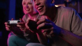Detail of young caucasian couple playing video game with game pads. Shot with RED helium camera in 8K. 