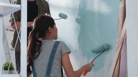 Peaceful Asian Cheerful couple young man and woman smiling sit together on floor painting white wall with roller during renovation house relocation in new apartment Happy couple painting walls - Powered by Shutterstock - Get 15% off with code: PIKWIZARD15
