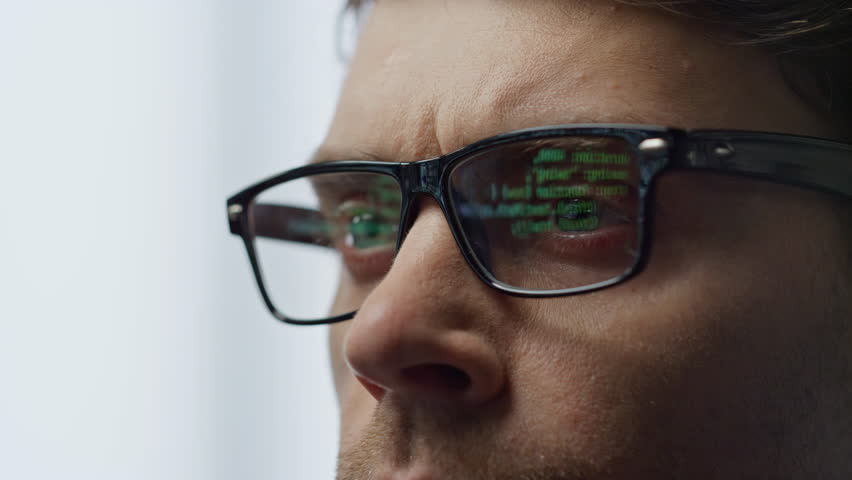 Software developer glasses reflecting terminal code closeup. It man hacker work computer tracking check java script network data. Focused freelancer professional coding overlook cyber security system Royalty-Free Stock Footage #1104643627