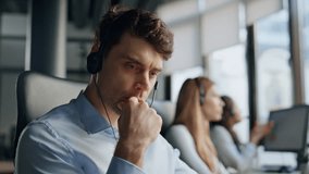 Thoughtful support agent listening customer at workplace. Focused man specialist helping client solving request on hotline. Serious professional manager work in data center. Helpdesk operator concept - Powered by Shutterstock - Get 15% off with code: PIKWIZARD15