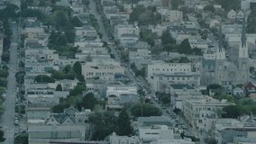 Early morning clip of city showing parallel streets lined with cars