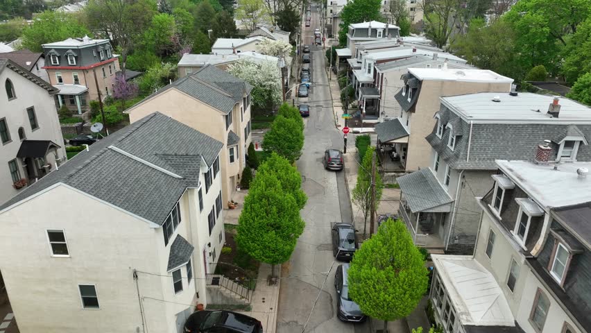 Aerial shot above historic street with houses in spring. Housing and homes in beautiful town in USA.