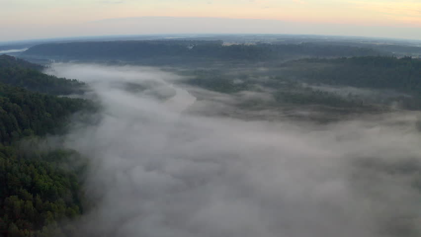 View of valley filled with fog - establishing shoot. Setting mood.