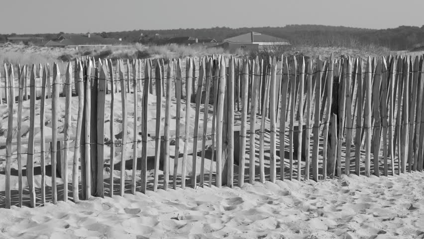 Vintage View Of Wooden Fence In Sand Dunes During Sunny Day. Close Up