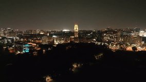 Vanderbilt University West End Tower at night with drone video moving in wide shot.