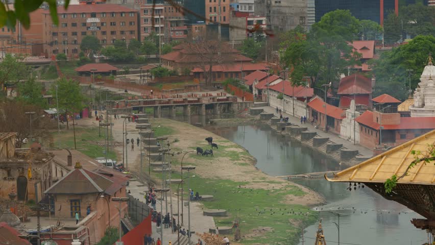 Landscape view of people visiting Pashupatinath Hindu Temple, next to Bagmati river, in Kathmandu, Nepal