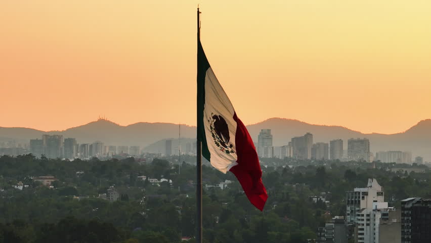 Aerial view of a large mexican flag, sunset in Mexico city - static, drone shot Royalty-Free Stock Footage #1104656647
