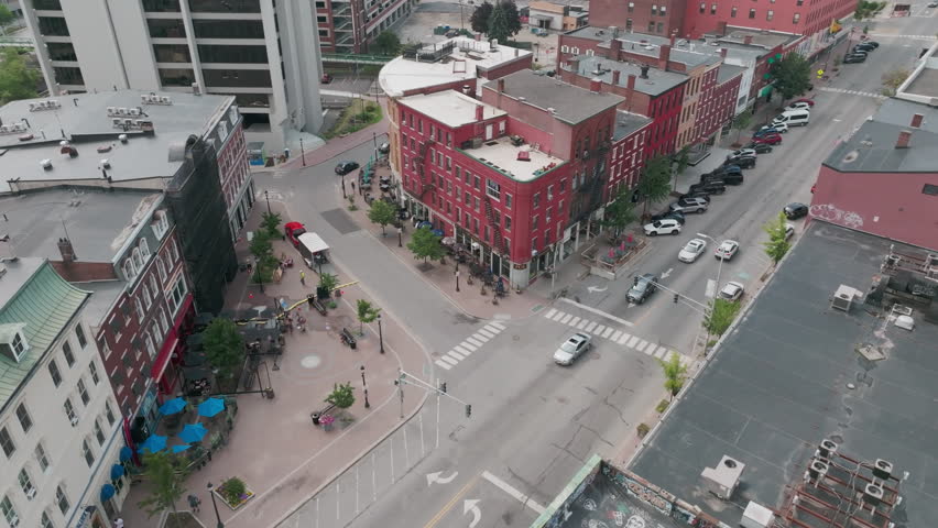 A Tight Drone Orbit Showcases Curved Brick Buildings on a Bangor, Maine Street Corner