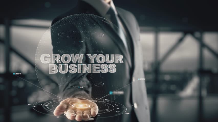 Businessman with Grow Your Business hologram concept