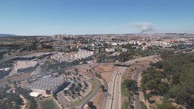 Drone pan shot of the Lisbon City Fire event from a distance. Highway traffic in Portugal.