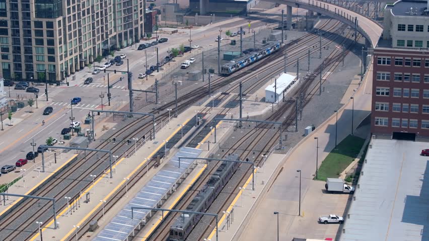 Amtrak train pulling into historic train station, Union Station in Denver, Colorado. Aerial establishing shot.