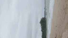vertical video of coast sea shore white sand smooth beach with turquoise tropical water sea with some wave,tropical nature summer landscape,vacation holiday background