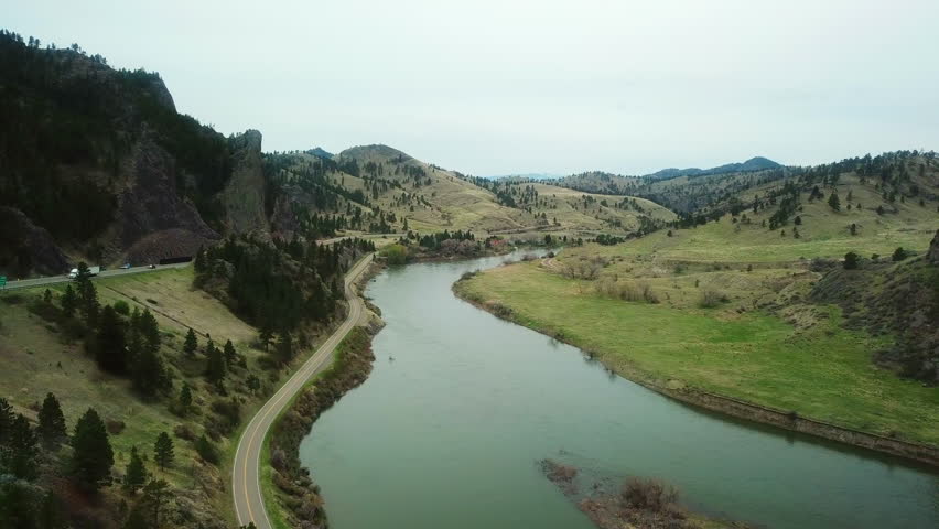 Aerial Shot Of River By Mountain Range Against Sky, Drone Flying Over Landscape - Billings, Montana