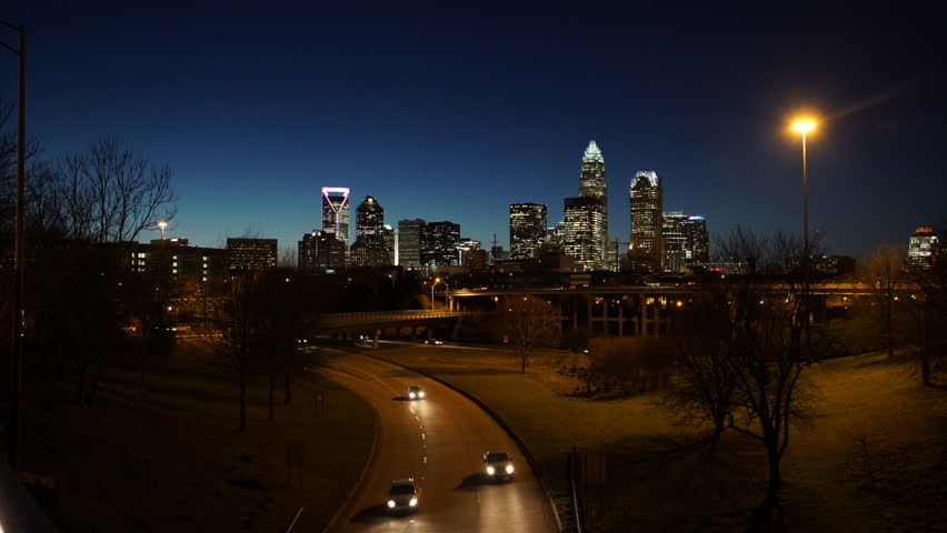 Lockdown Shot Of Vehicles On Road And Bridge In Illuminated City Against Sky At Night - Charlotte, North Carolina