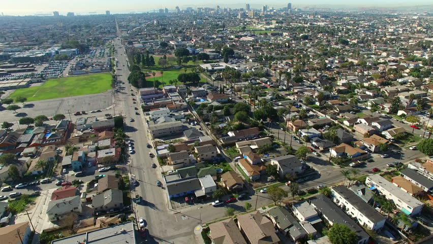 Aerial Tilt Down Shot Of Houses Near Downtown On Sunny Day, Drone Flying Forward Over Suburb In City - Long Beach, California